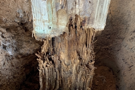 Damaged foundation wood pile before MDH Foundation Repair